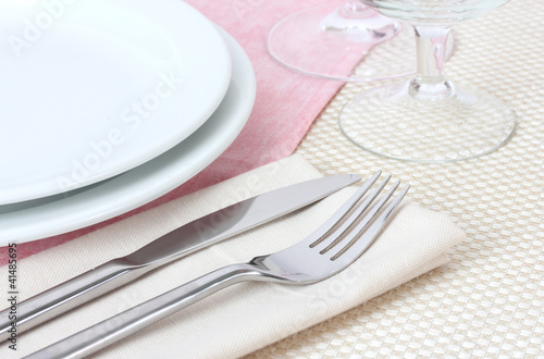 Table setting with fork  knife  plates  and napkin