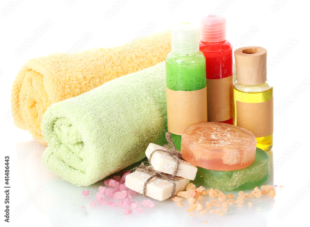 Bottles, soaps, sea salt and towels isolated on white Bottles, soaps, sea salt and towels isolated on white