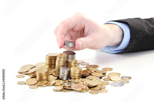 Businessman hand put coins isolated on white