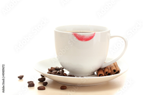 cup of coffee with lipstick mark beans and cinnamon sticks