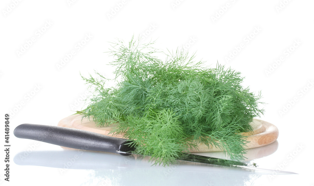 Fototapeta premium Dill on a cutting board with knife isolated on white