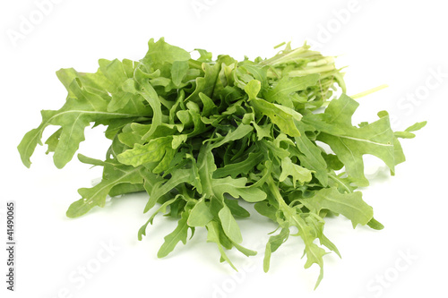 Fresh rucola salad or rocket lettuce leaves isolated on white