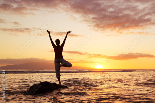 Silhouette of a Beautiful Yoga Woman at Sunset © EpicStockMedia