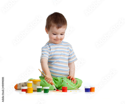 kid drawing with paints