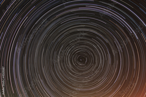 Cumulative time lapse of star trails in night sky.