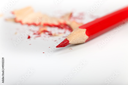 red pen with pencil shavings in the background photo