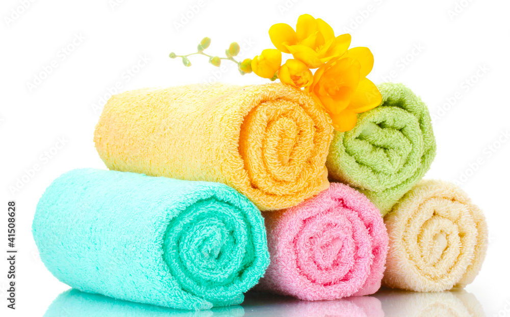 colorful towels and flowers isolated on white colorful towels and flowers isolated on white