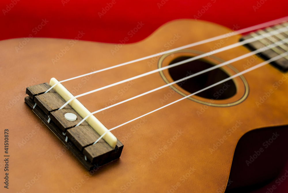 Fototapeta premium Vintage ukulele on red background