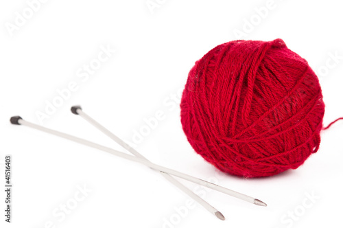 Knitting needles and red ball of yarn