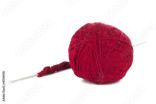 Knitting needles and red ball of yarn