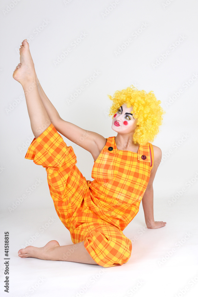 Clown in colourful costume doing gymnastic Clown in colourful costume doing gymnastic