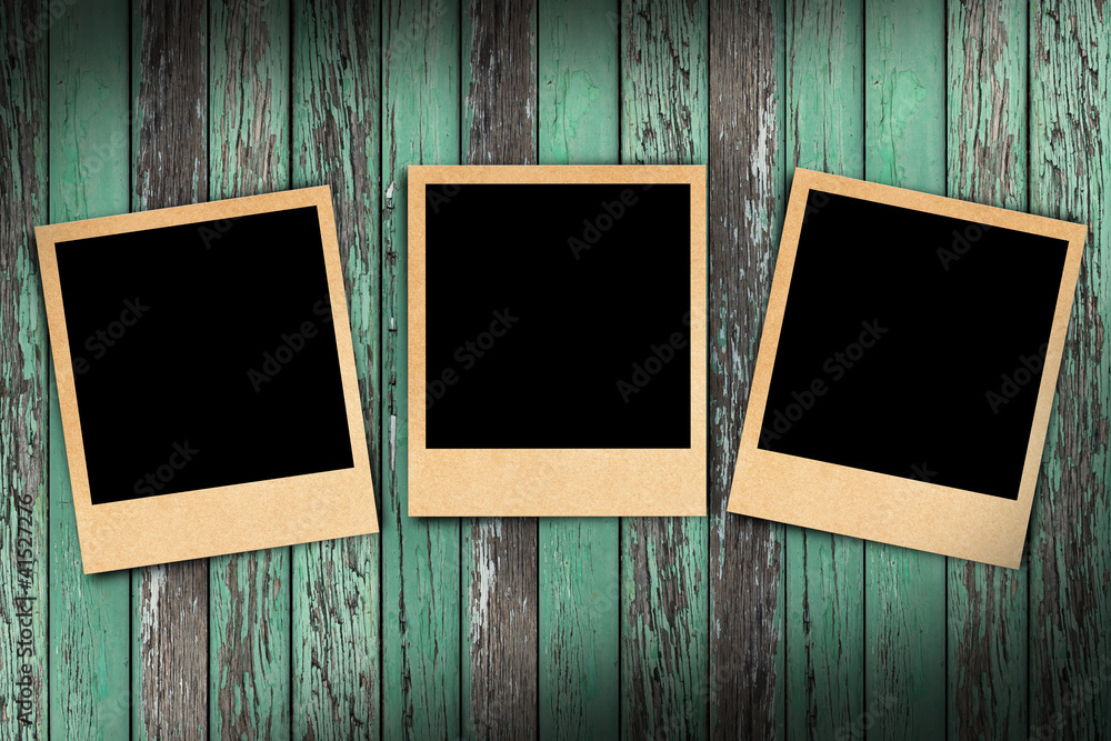 Blank instant photo frames on old wooden background. Blank instant photo frames on old wooden background.