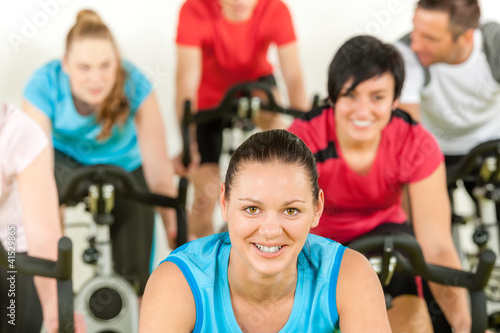 Smiling woman at spinning class fitness workout