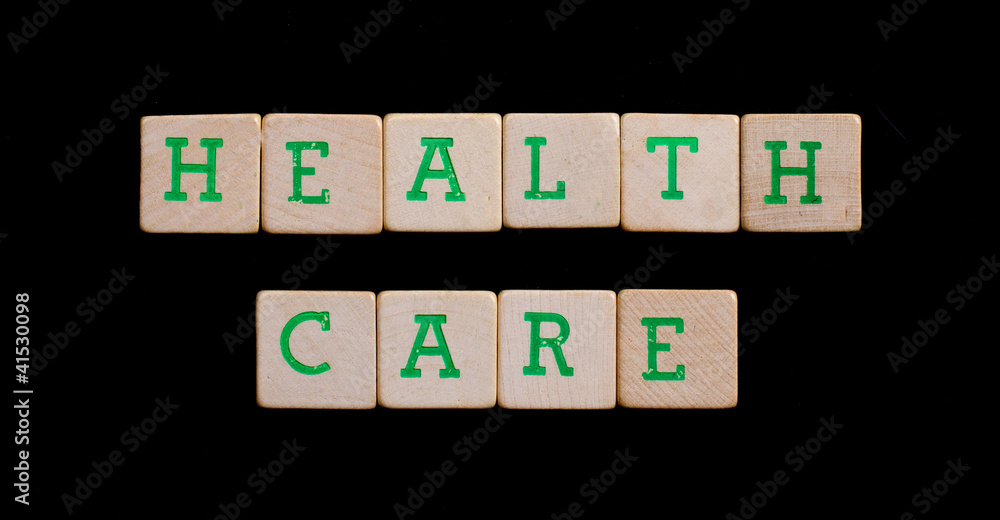 Green letters on old wooden blocks (health, care) Green letters on old wooden blocks (health, care)