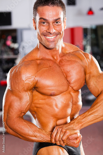 professional male bodybuilder posing in gym