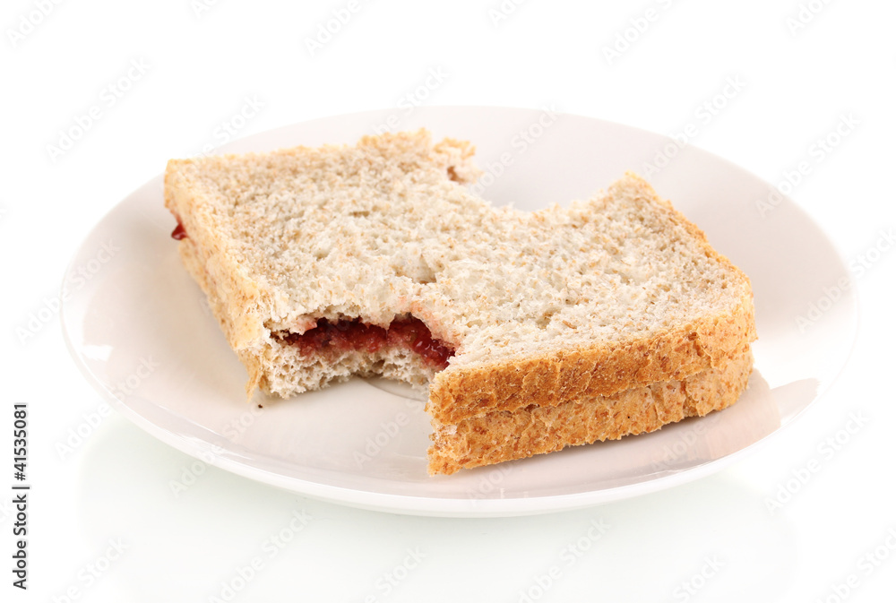 Bitten sandwich with jam on plate isolated on white