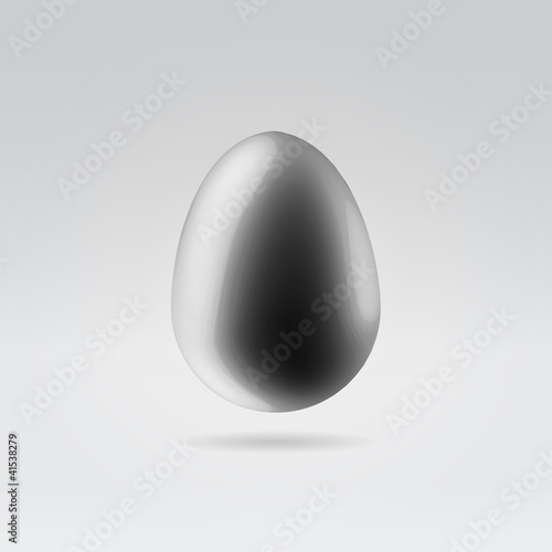 Pure black glossy plastic egg hanging in space