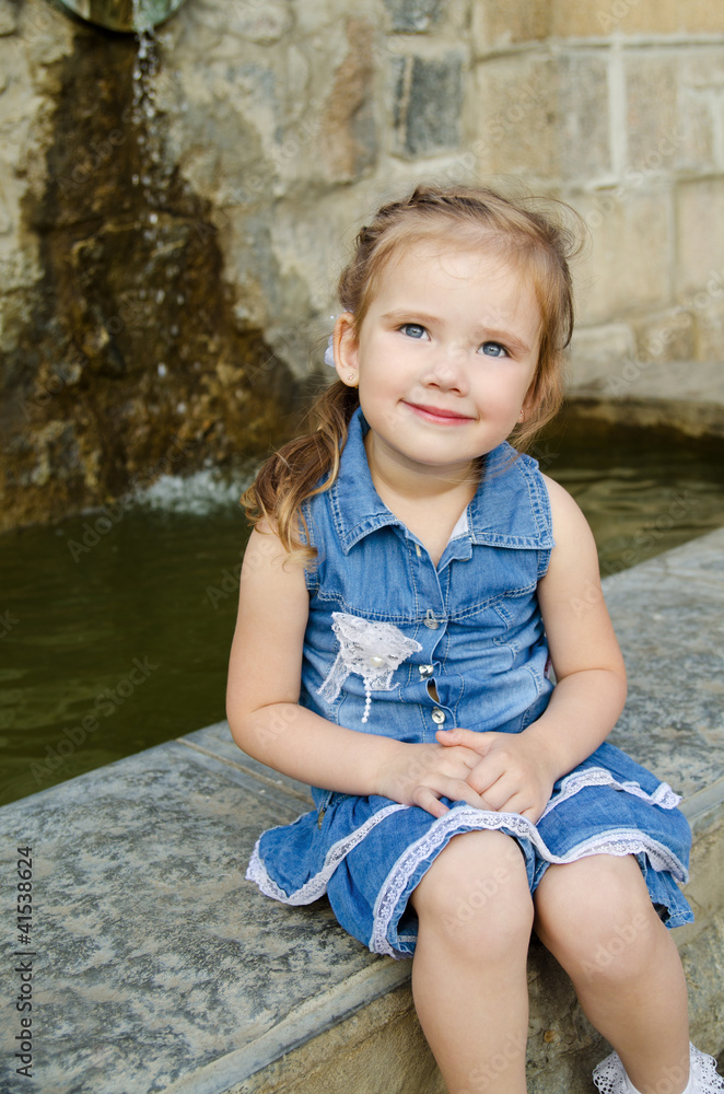 Portrait of smiling  little girl in dress outdoor