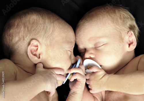New born twins with dummies