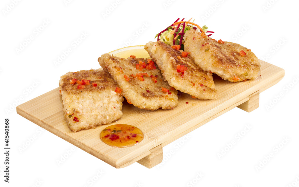 Fried fish fillets with  salad.