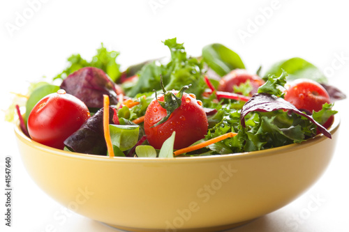 Bowl of fresh green salad with tomatoes