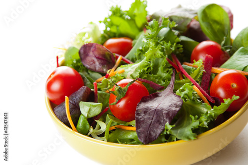 Bowl of fresh green salad with tomatoes