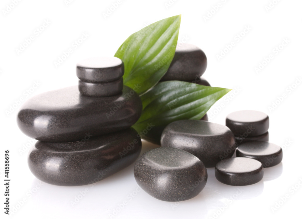 Spa stones and green leaves isolated on white Spa stones and green leaves isolated on white