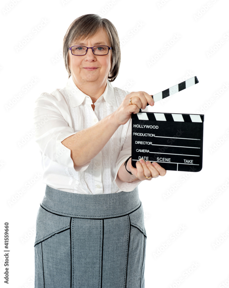 Attractive senior woman using clapperboard Attractive senior woman using clapperboard