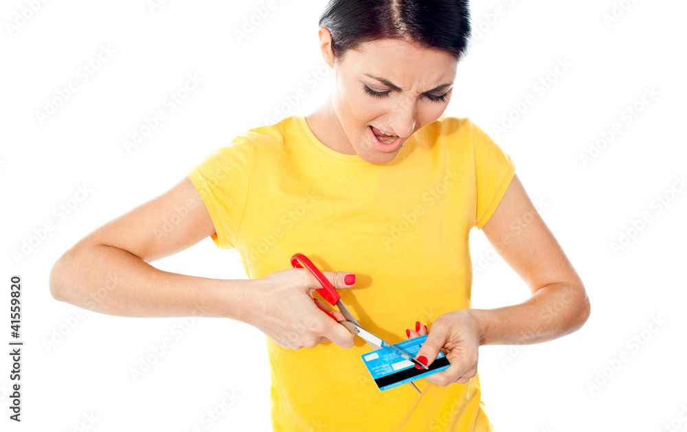Unhappy female customer destroying her atm card Unhappy female customer destroying her atm card
