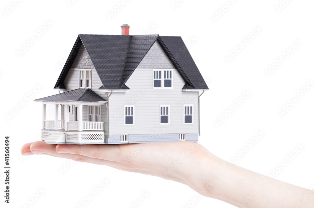Hand holding house architectural model, isolated Hand holding house architectural model, isolated