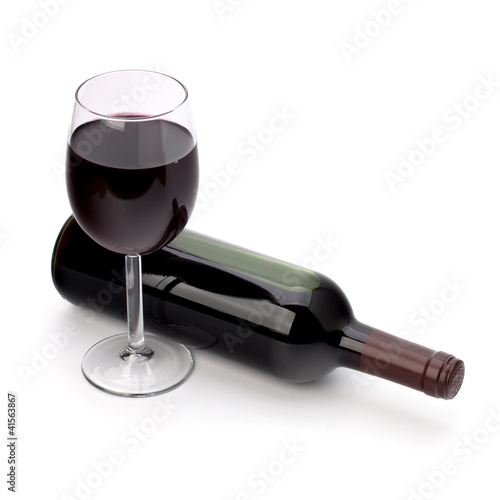 Full red wine glass goblet and bottle