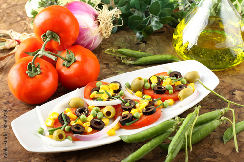 Salad of tomato, olives, corn and peas