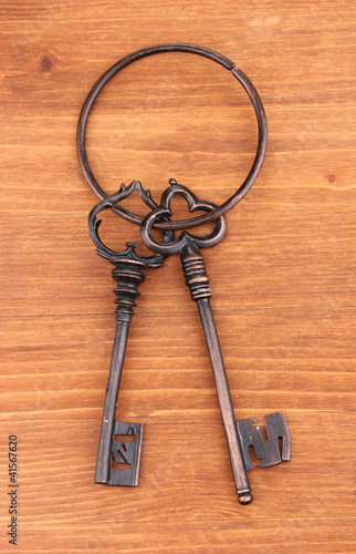 a bunch of antique keys on wooden background © Africa Studio
