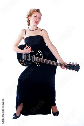 woman playing electricguitar on studio isolated white backgr