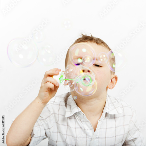The little boy and soap bubbles. Carefree. childhood
