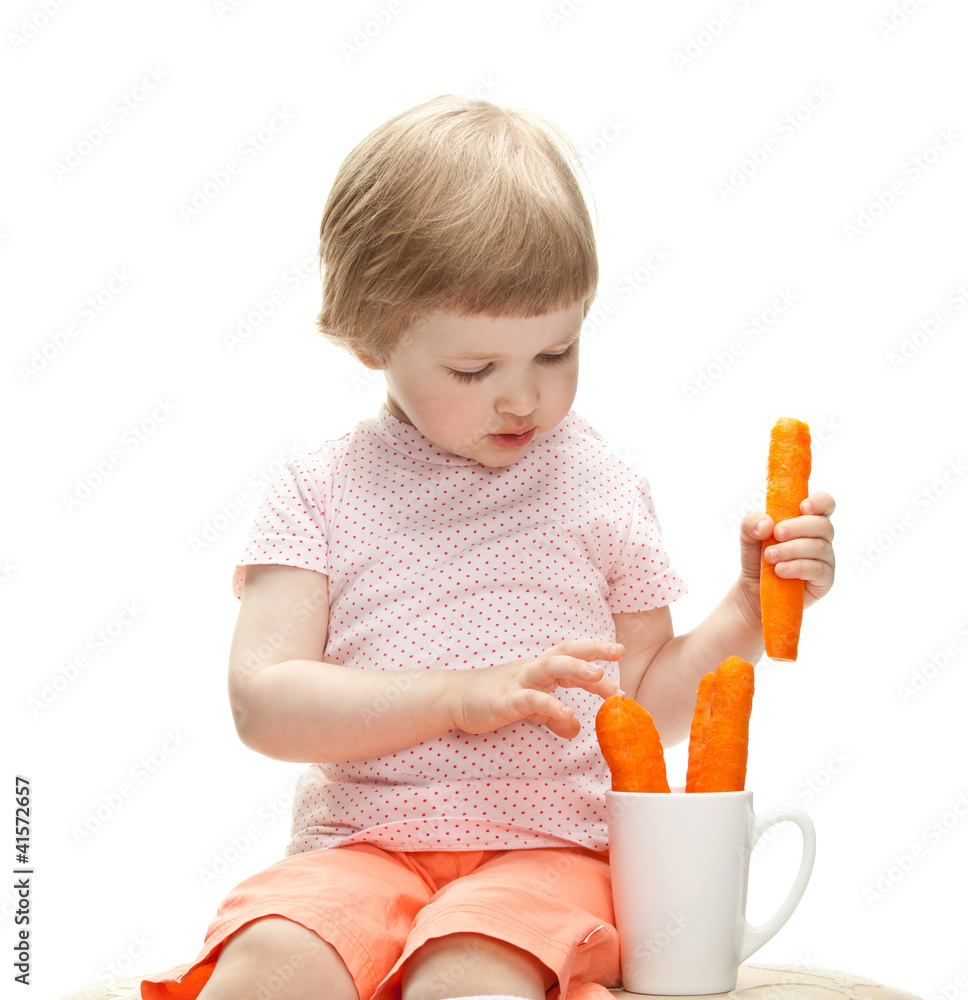 Little baby girl playing with fresh carrots Little baby girl playing with fresh carrots