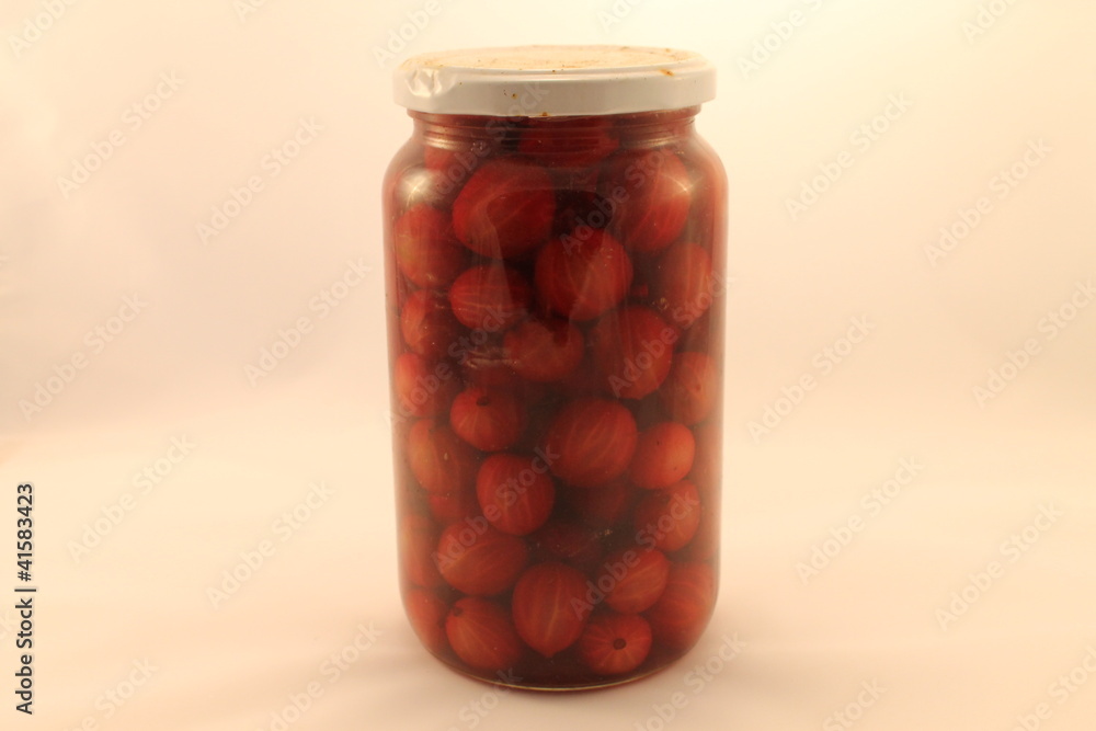 cherries and gooseberries in glass jar cherries and gooseberries in glass jar