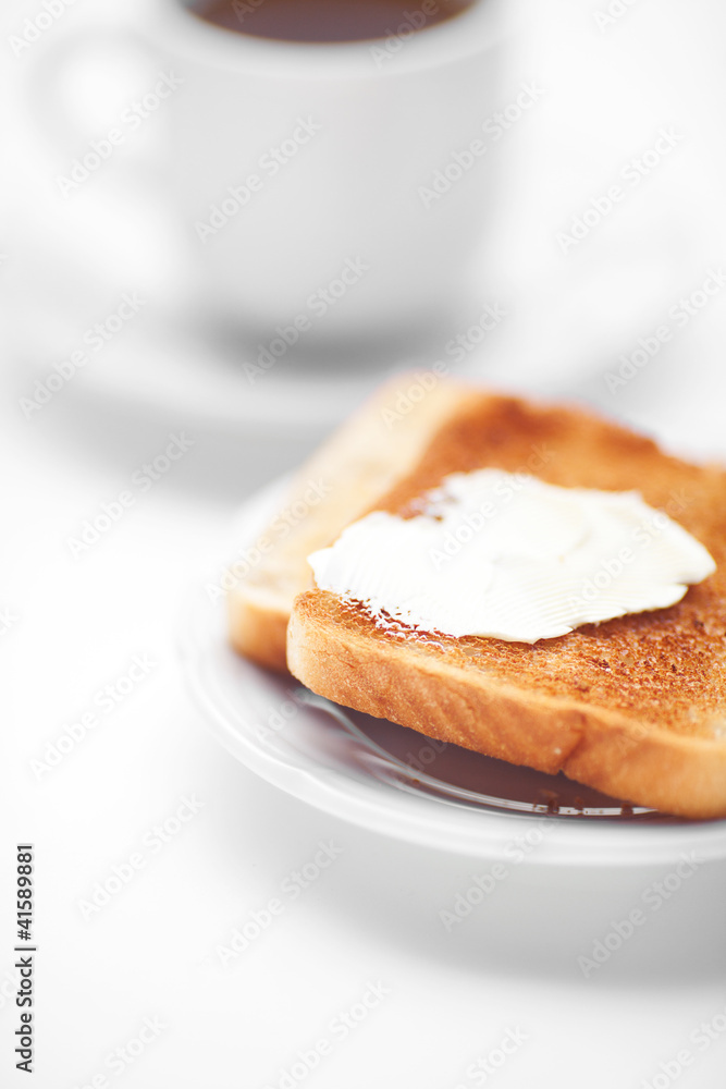 tea and toast with butter isolated on white tea and toast with butter isolated on white