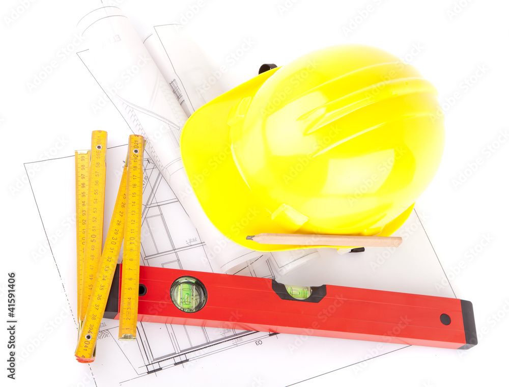 yellow hardhat, tools and construction plans yellow hardhat, tools and construction plans