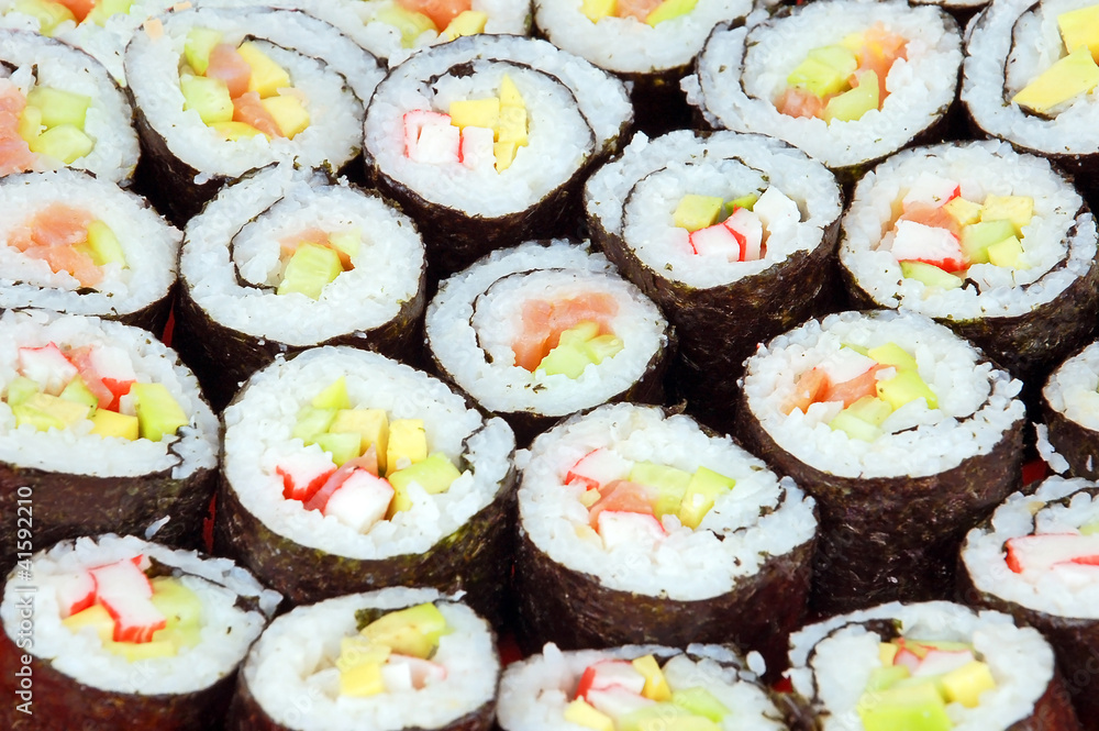 Japanese cuisine - sushi roll with salmon and avocado Japanese cuisine - sushi roll with salmon and avocado