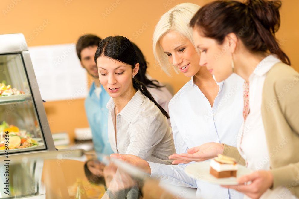 Fototapeta premium Cafeteria food young woman choose dessert