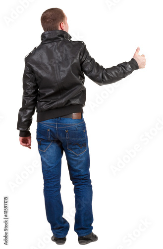Back view of  man shows thumbs up.