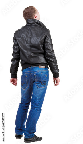 Back view of handsome man in jacket looking up.