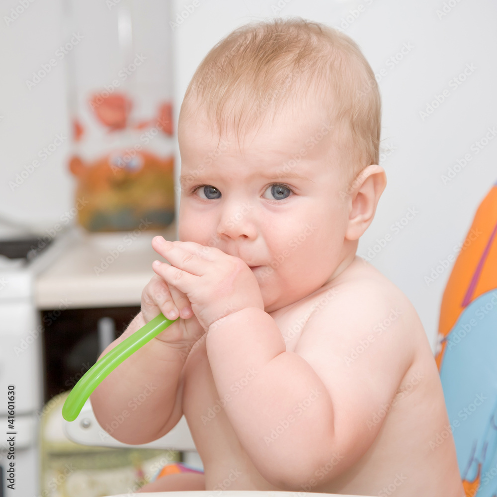 Cute baby boy with spoon in mouth Cute baby boy with spoon in mouth