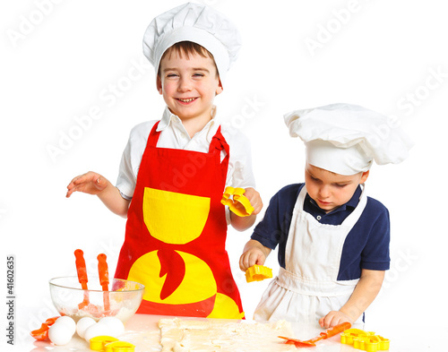 Two beautiful caucasian brothers making a cake photo