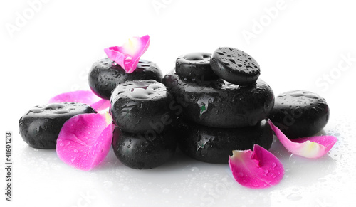 Spa stones with drops and rose petals isolated on white