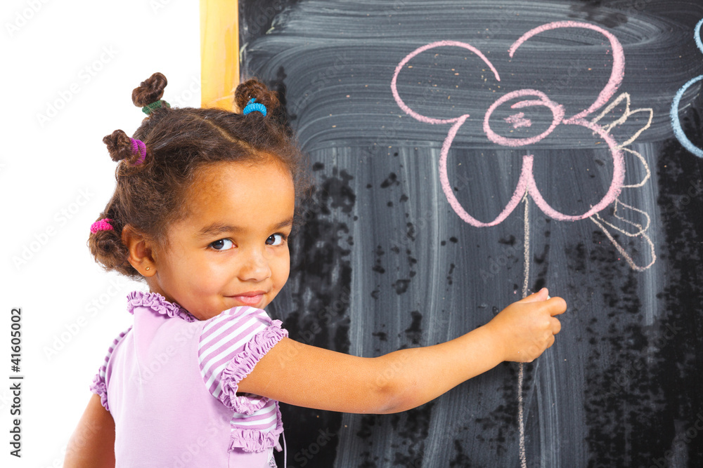 Little girl draws on the board