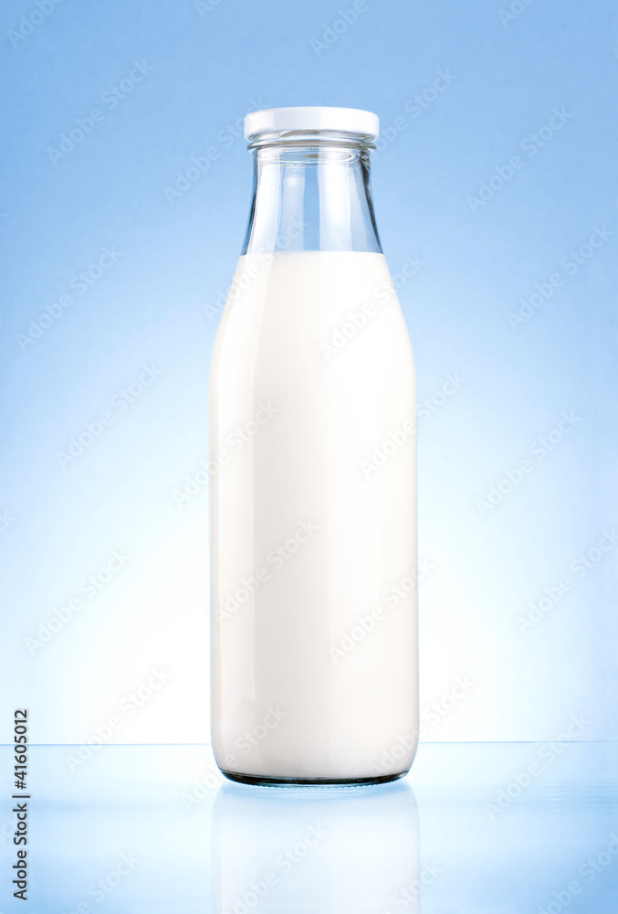 Bottle of fresh milk isolated on a blue background Bottle of fresh milk isolated on a blue background