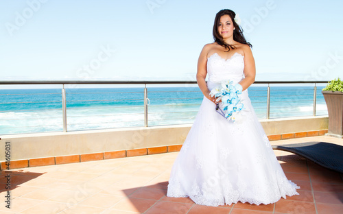 beautiful bride with bouquet and sea view © michaeljung