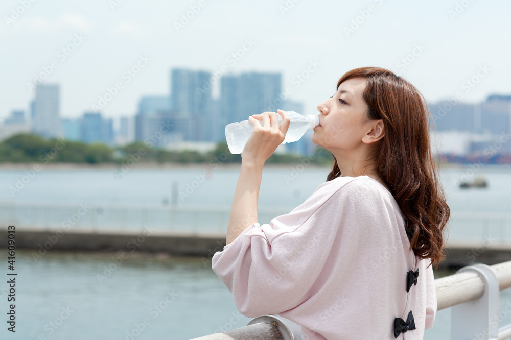 Beautiful young woman drinking water. Portrait of asian woman. Beautiful young woman drinking water. Portrait of asian woman.